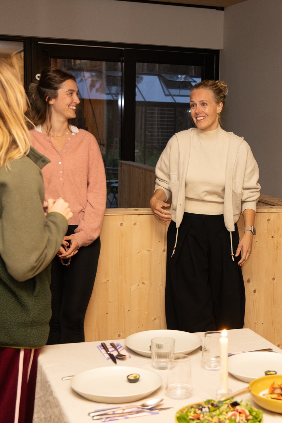 Twee deelnemers lachend bij de gedekte tafel